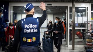 Belgian police officers control travellers of the Eurostar train earlier this month