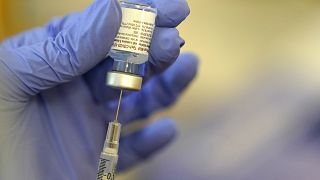 A pharmacist prepares a syringe of the Pfizer-BioNTech COVID-19 vaccine Friday, Jan. 8, 2021.