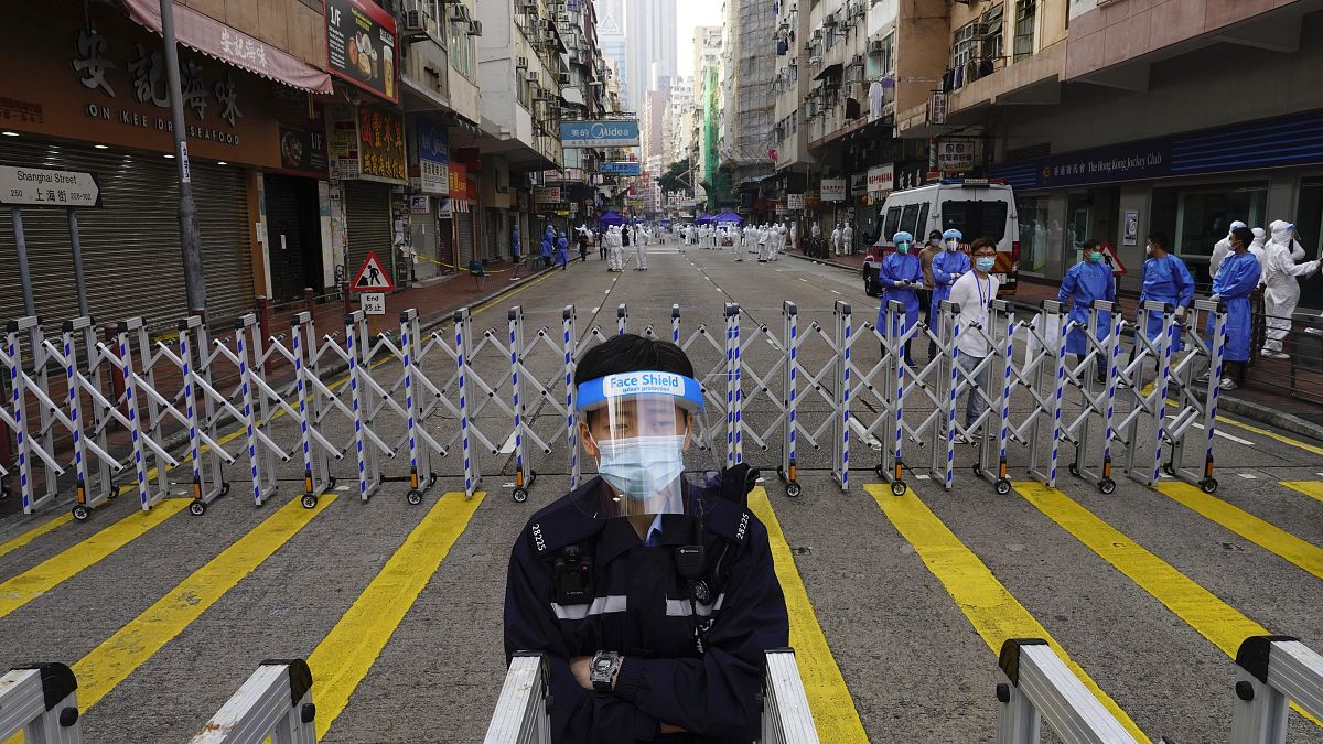 A police officer stands guard at the Yau Ma Tei area, in Hong Kong, Saturday, Jan. 23, 2021. 