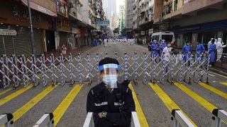 A police officer stands guard at the Yau Ma Tei area, in Hong Kong, Saturday, Jan. 23, 2021. 