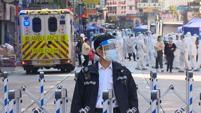 Policemen and medical staff behind barrier in Jordan and Yau Ma Tei district, Hong Kong on Saturday.