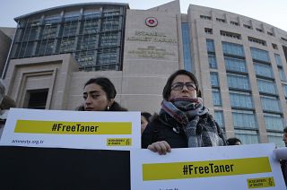 FILE: Human rights activists stage a protest outside a court in Istanbul, Wednesday, Jan. 31, 2018.