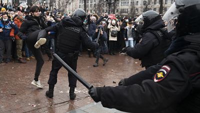 A demonstrator clashes with a police officer during a protest against the jailing of opposition leader Alexei Navalny in Moscow, Russia, Jan. 23, 2021