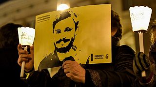 Amnesty International activists hold a picture of Giulio Regeni at a demonstration in Rome on January 25, 2017.