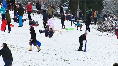 Britons enjoy snow with social distancing in mind