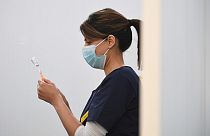 Pharmacist draws a dose of Oxford/AstraZeneca Covid-19