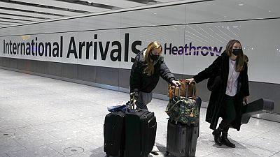 Travellers arrive at Heathrow Airport in London, Sunday, Jan. 17, 2021.
