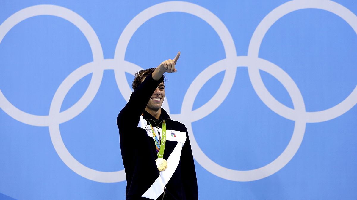 Italy's Gregorio Paltrinieri celebrates his gold during the medal ceremony for the men's 1500-meter freestyle final during the swimming competitions at the 2016 Rio Olympic.