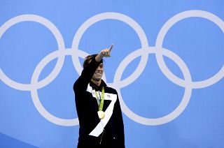 Italy's Gregorio Paltrinieri celebrates his gold during the medal ceremony for the men's 1500-meter freestyle final during the swimming competitions at the 2016 Rio Olympic.