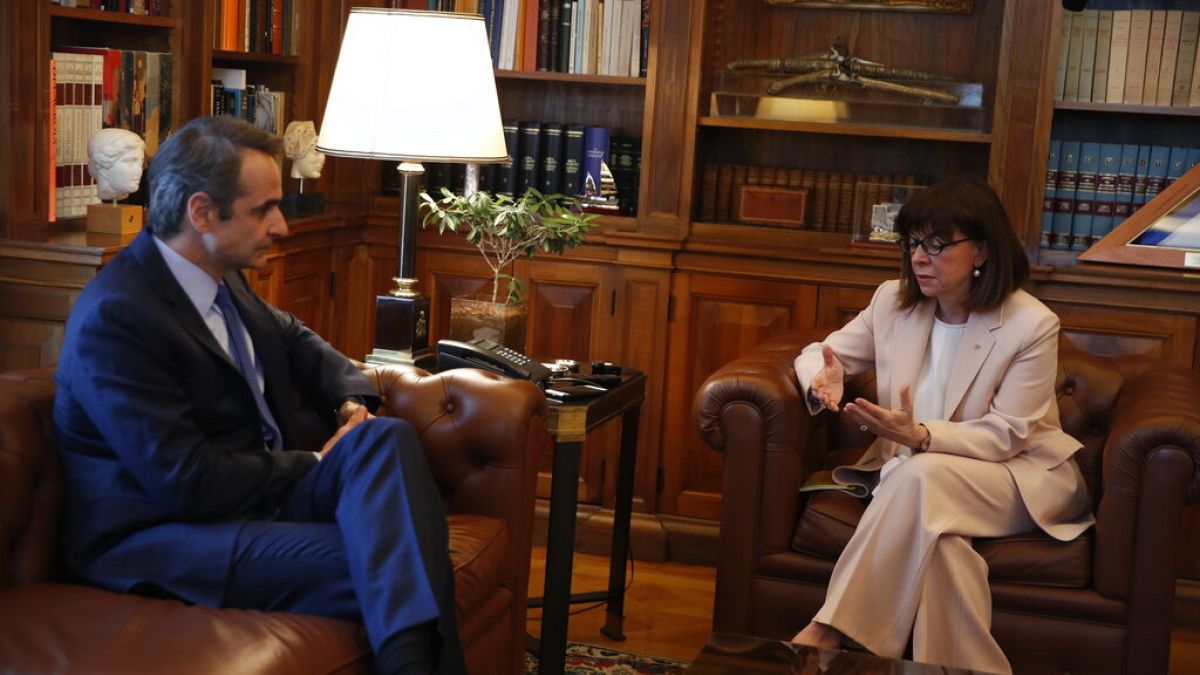 Greece's President Katerina Sakellaropoulou, right, talks to Prime Minister Kyriakos Mitsotakis