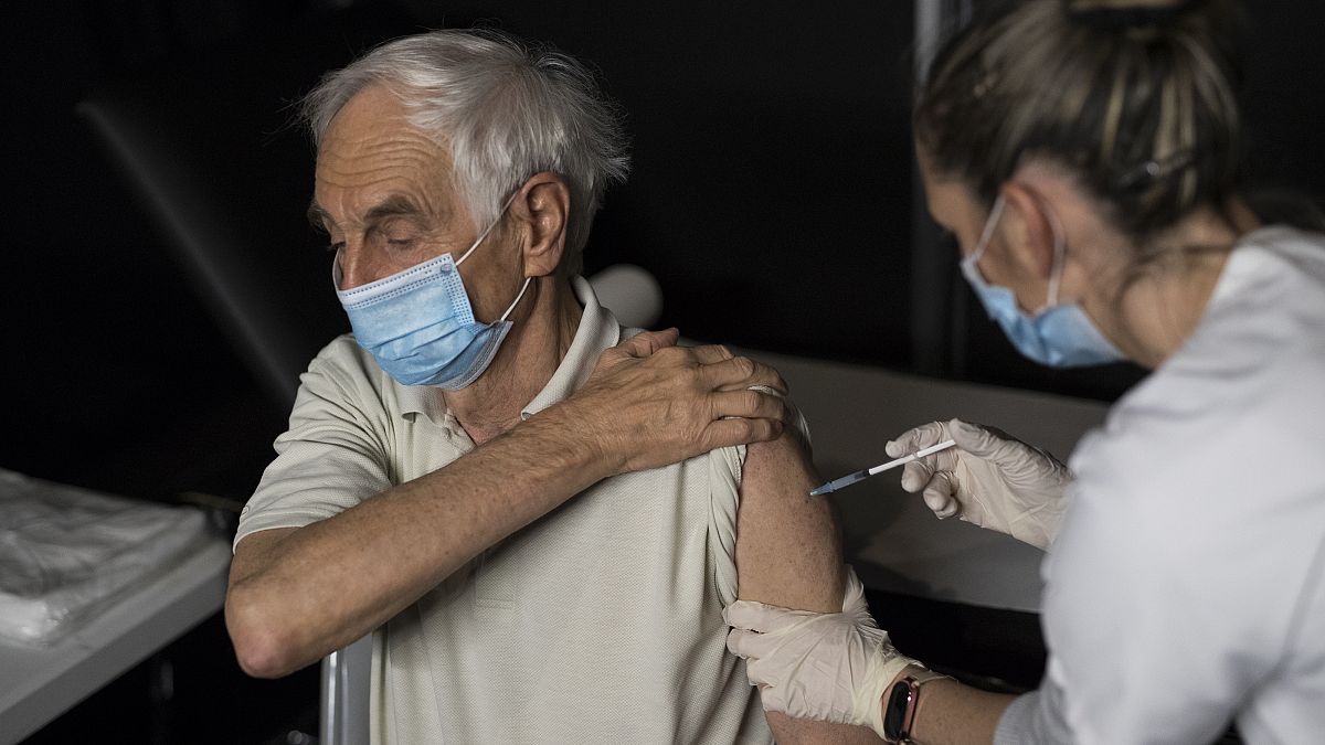A nurse administers a dose of the Moderna COVID-19 vaccine at a vaccination center in Le Cannet, southern France, Jan. 21, 2021.