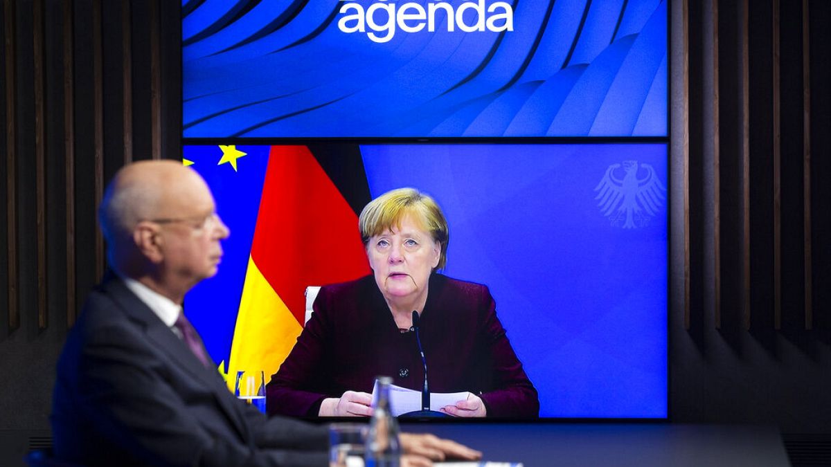 German Klaus Schwab, left, Founder and Executive Chairman of the World Economic Forum, WEF, listens to German Chancellor Angela Merkel