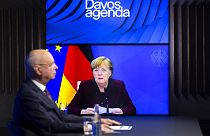German Klaus Schwab, left, Founder and Executive Chairman of the World Economic Forum, WEF, listens to German Chancellor Angela Merkel