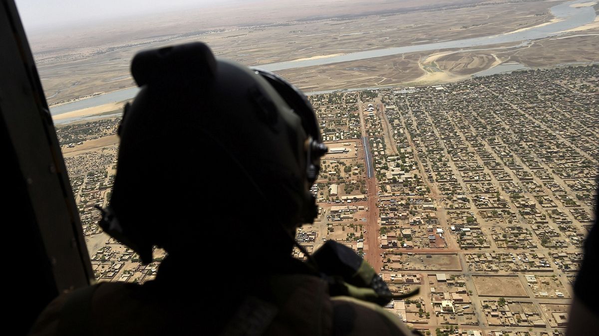 A French soldier stands inside a military helicopter on operation in Mali.