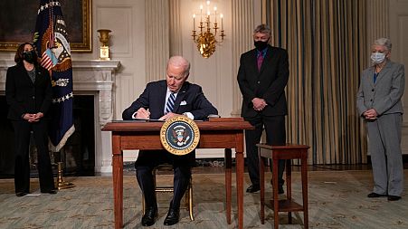 President Joe Biden signs a series of executive orders on climate change, in the State Dining Room of the White House, Wednesday, Jan. 27, 2021, in Washington. 