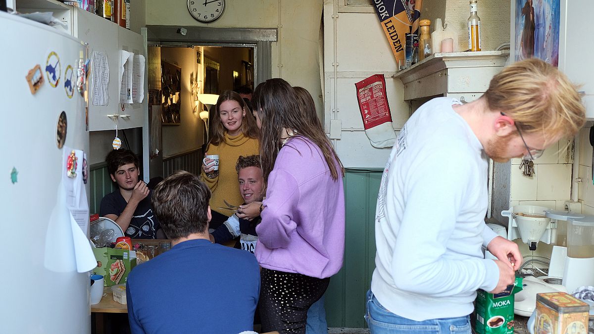Dutch students chat in the kitchen of their shared house in Netherlands