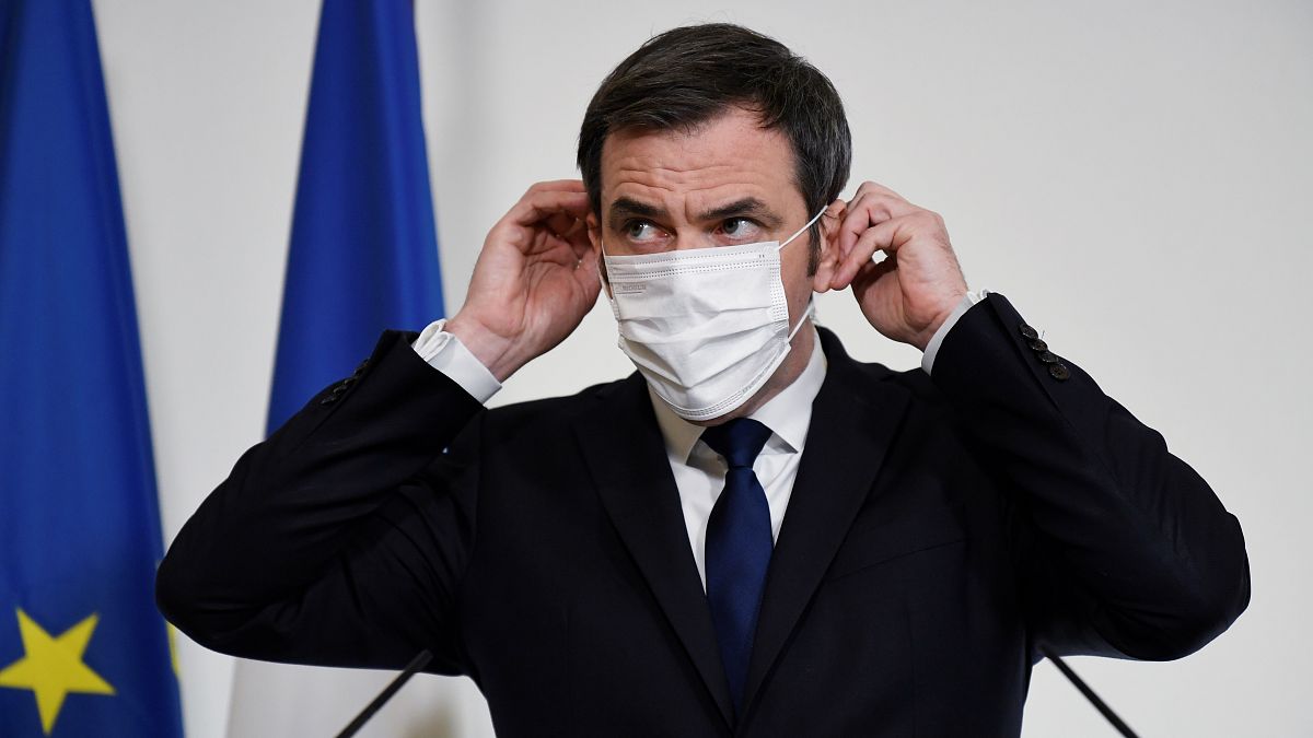French Health Minister Olivier Veran adjusts his mask during a press conference on Tuesday Jan. 26, 2021 in Paris.