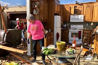 Patti Herring sobs as she sorts through the remains of her home after it was destroyed by a tornado. Fultondale, Alabama, USA. January 26, 2021