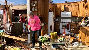 Patti Herring sobs as she sorts through the remains of her home after it was destroyed by a tornado. Fultondale, Alabama, USA. January 26, 2021