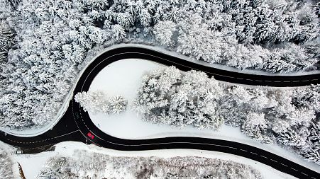 Cars on the Col du Mollendruz mountain pass after snowfall in the Jura Mountains, Mont-la-Ville, Switzerland