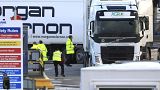 Customs officials check vehicles at the P&O ferry terminal in the port at Larne on the north coast of Northern Ireland, Friday, Jan. 1, 2021. 