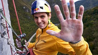 Domen Skofic resting at a belay on the Trbovlje Chimney in Trbovlje, Slovenia