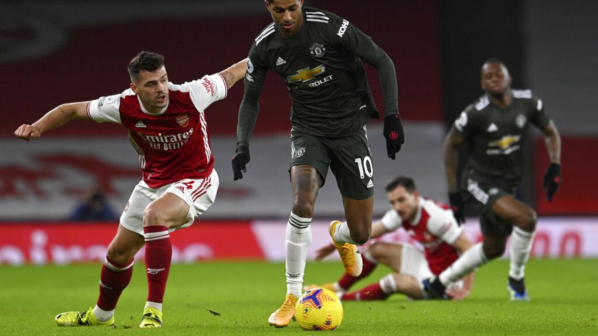 Manchester United's Marcus Rashford, right, duels for the ball with Arsenal's Granit Xhaka during the English Premier League match between Arsenal and Manchester United