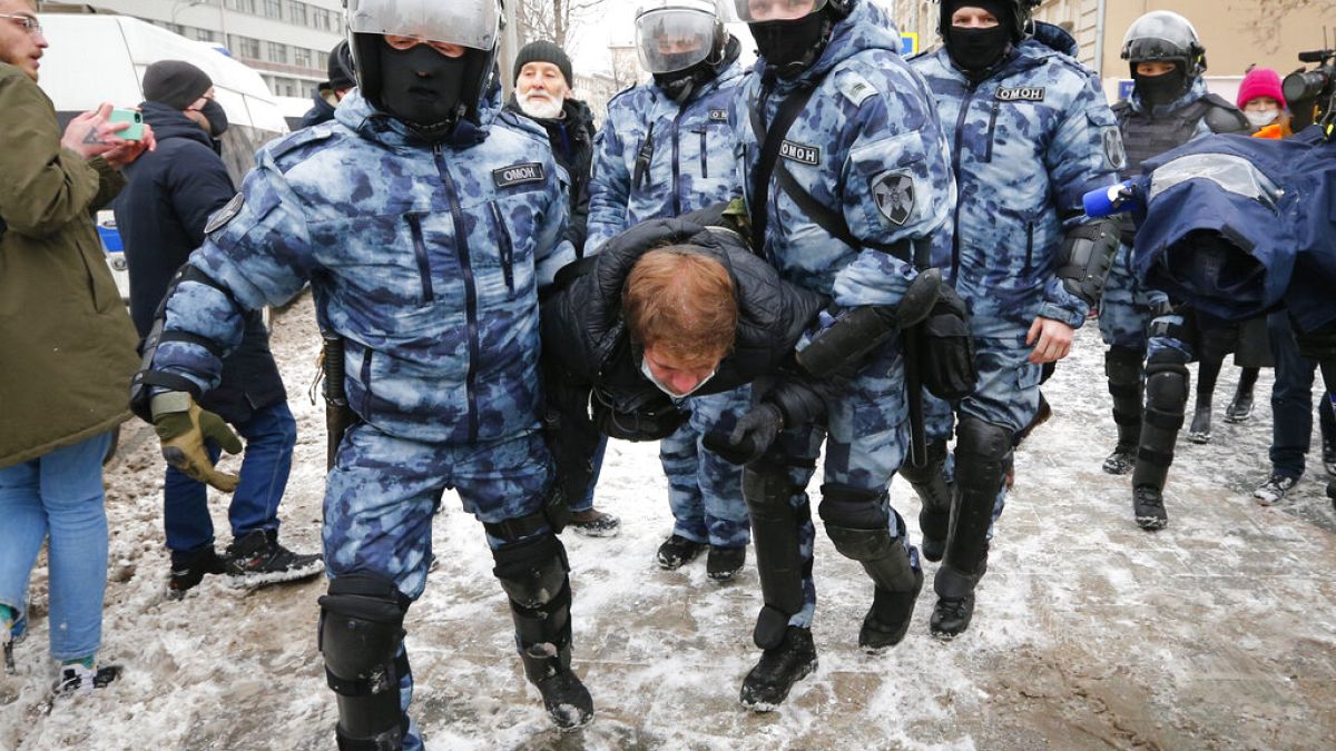 Police officers detain a man during a protest against the jailing of opposition leader Alexei Navalny in Moscow, Russia, on Sunday, Jan. 31, 2021.