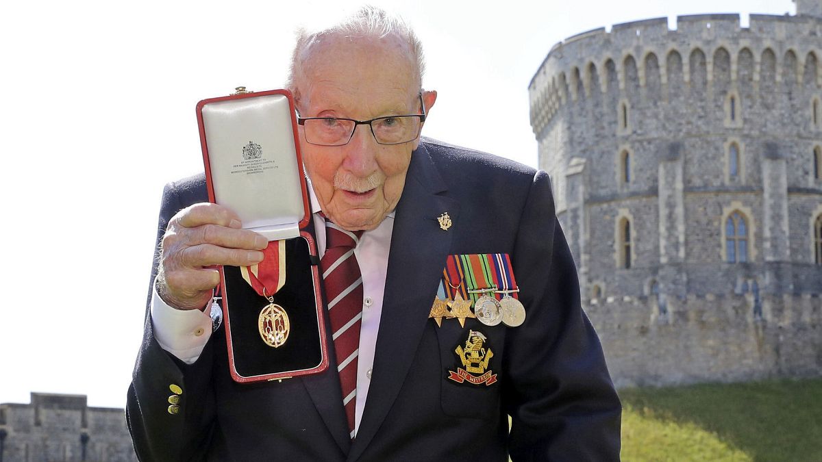 Captain Sir Thomas Moore poses for the media after receiving his knighthood from Britain's Queen Elizabeth, during a ceremony at Windsor Castle in Windsor, England.