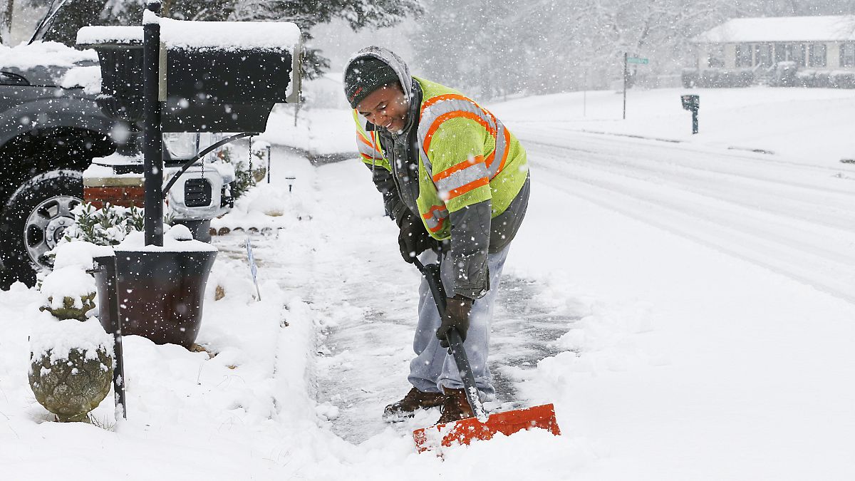 Antwan Wilkerson shovels snow during a winter storm, Sunday, Jan. 31, 2021, in Mechanicsville, Va.