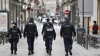 Police officers patrol near Le Printemps shopping centre in Paris as big shopping centres are closed as a measure taken to curb the spread of the Covid-19