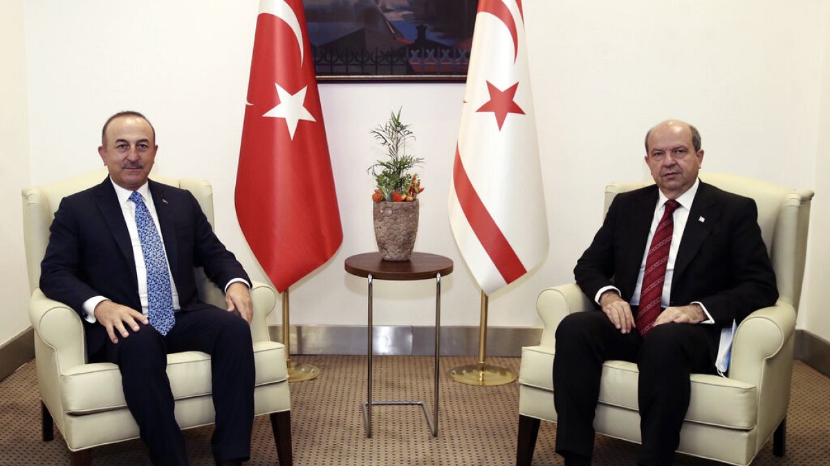 Turkey's Foreign Minister Mevlut Cavusoglu, left, and Ersin Tatar,
