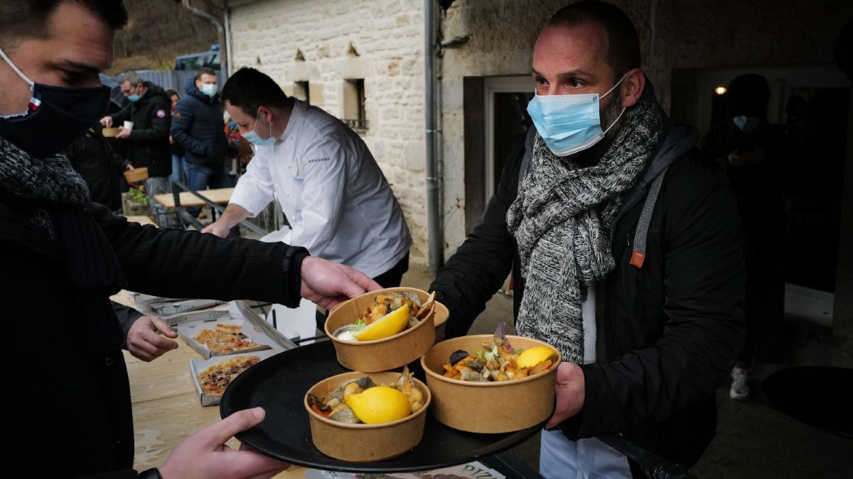 French chef Stephane Turillon serves meals outside his restaurant "La source bleue" in Cusance, eastern France, on February 1, 2021