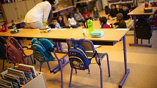 A teacher, wearing a face mask to fight against the spread of the coronavirus during school at the Heembeek primary school in Brussels, Tuesday, Sept. 1, 2020.