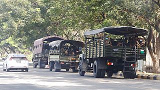 Soldiers sit inside trucks parked on a road in Naypyitaw, Myanmar, Monday, Feb. 1, 2021. 