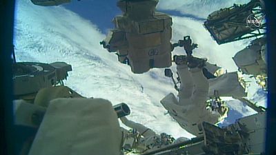 Astronaut installing final adapter plate