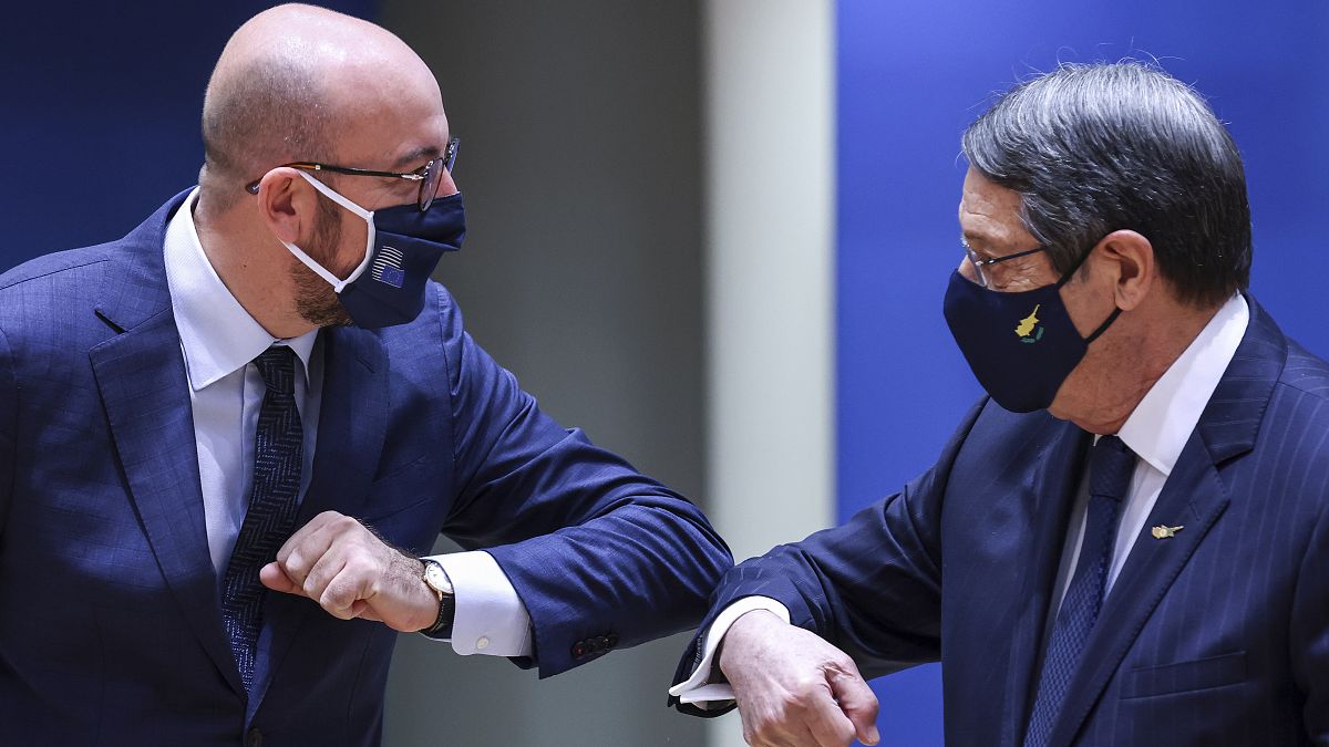 European Council President Charles Michel, left, greets Cypriot President Nicos Anastasiades