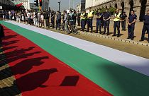 Protestors' shadows are cast on a giant Bulgarian flag amid demonstrations in Sofia demanding the government's resignation