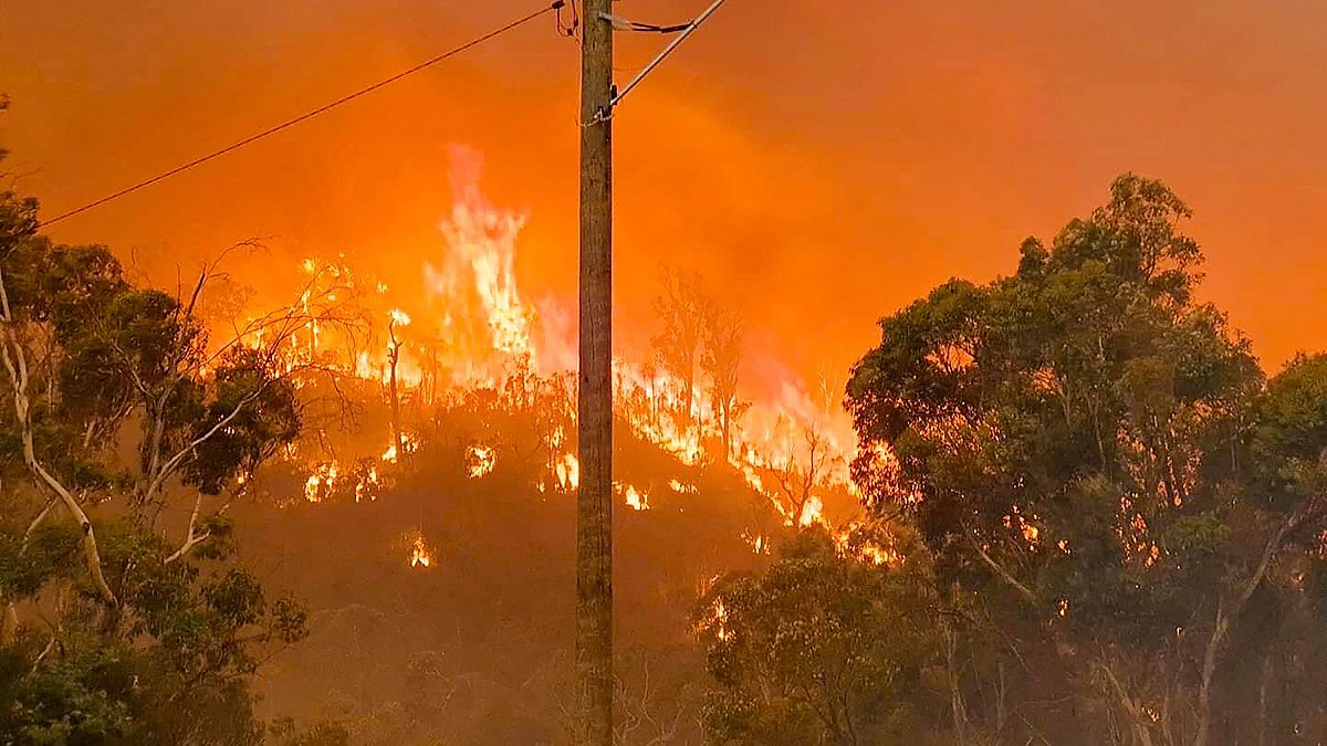 In this photo provided by Department of Fire and Emergency Services, fire burns on a hill at Wooroloo, near Perth, Australia