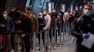 People queue at a Covid-19 test center at the airport in Frankfurt, Germany