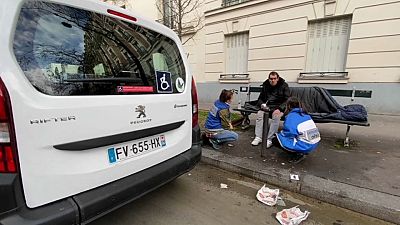 SAMU Social nurse helping homeless man on streets of Paris