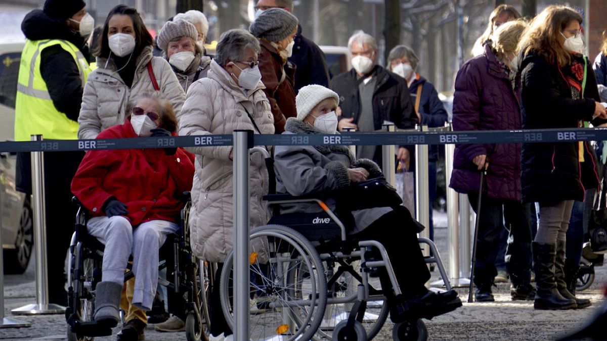 People queue in front of the vaccination center against the COVID -19 disease at the 'Arena Treptow' in Berlin, Germany, Monday, Feb. 1, 2021. 