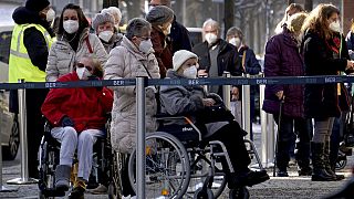 People queue in front of the vaccination center against the COVID -19 disease at the 'Arena Treptow' in Berlin, Germany, Monday, Feb. 1, 2021. 