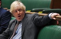 In this handout photo provided by UK Parliament, Britain's Prime Minister Boris Johnson looks on during Prime Minister's Questions in the House of Commons, London, Wednesday, 