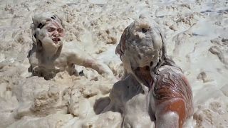 Sea foam on Argentine beach delights vacationers