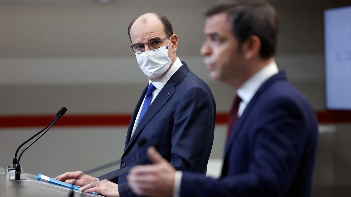 French Prime Minister Jean Castex, left, looks on as French Health Minister Olivier Veran speaks during a press conference in Paris, Thursday, Jan. 14, 2021.