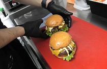 Juan Diego Gaitán prepares burgers in his 'dark kitchen' in Madrid