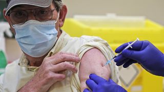 Doctor PJ Suresh injects a patient with the Pfizer/BioNtech COVID-19 vaccine at the Fullwell Cross Medical Centre in Ilford, London, Friday, Jan. 29, 2021. 