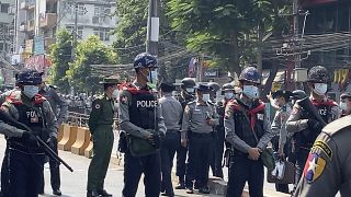 In this image made from video, Myanmar police block the road to prevent protesters from marching forward Saturday, Feb. 6, 2021 in Yangon, Myanmar. 