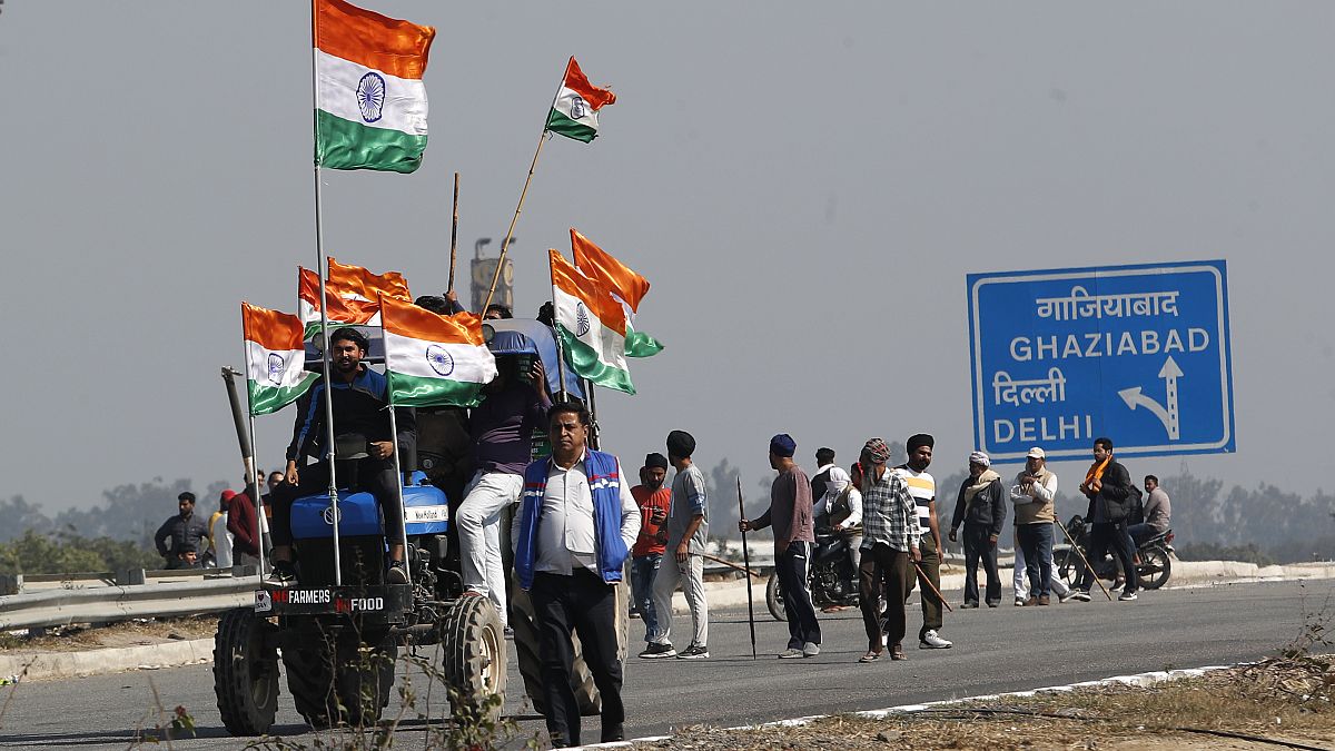 Indian farmers block an expressway at Kundli in Haryana, India, Saturday, Feb. 6, 2021. 